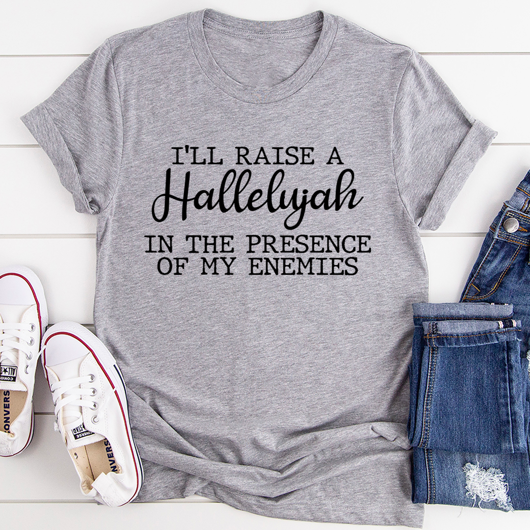 A black t-shirt featuring the phrase 'I'll Raise A Halleluyah In The Presence Of My Enemies' in stylish typography, made from soft cotton.